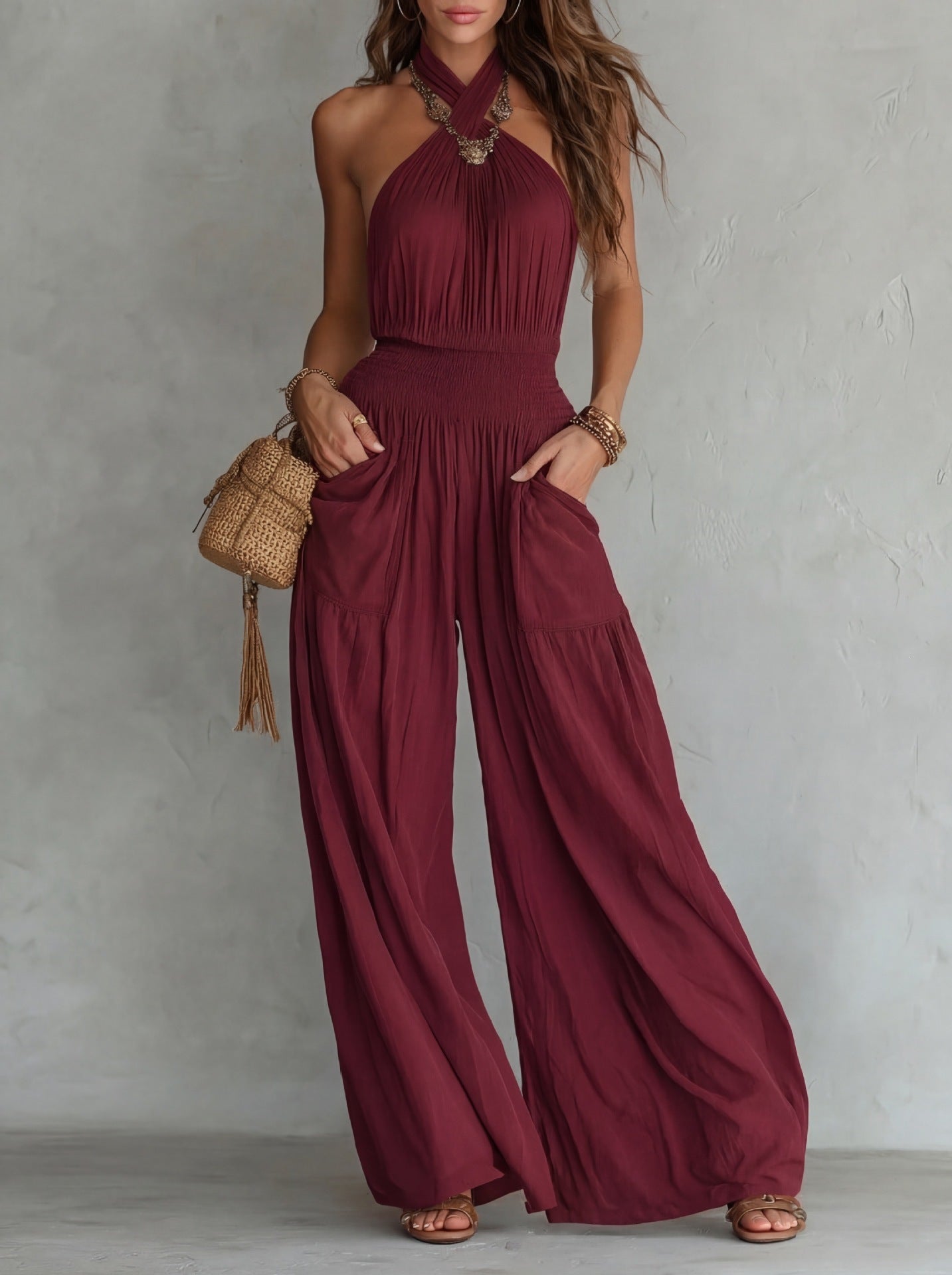 Burgundy bohemian backless sleeveless wide leg jumpsuit with drawstring waist and functional pockets.