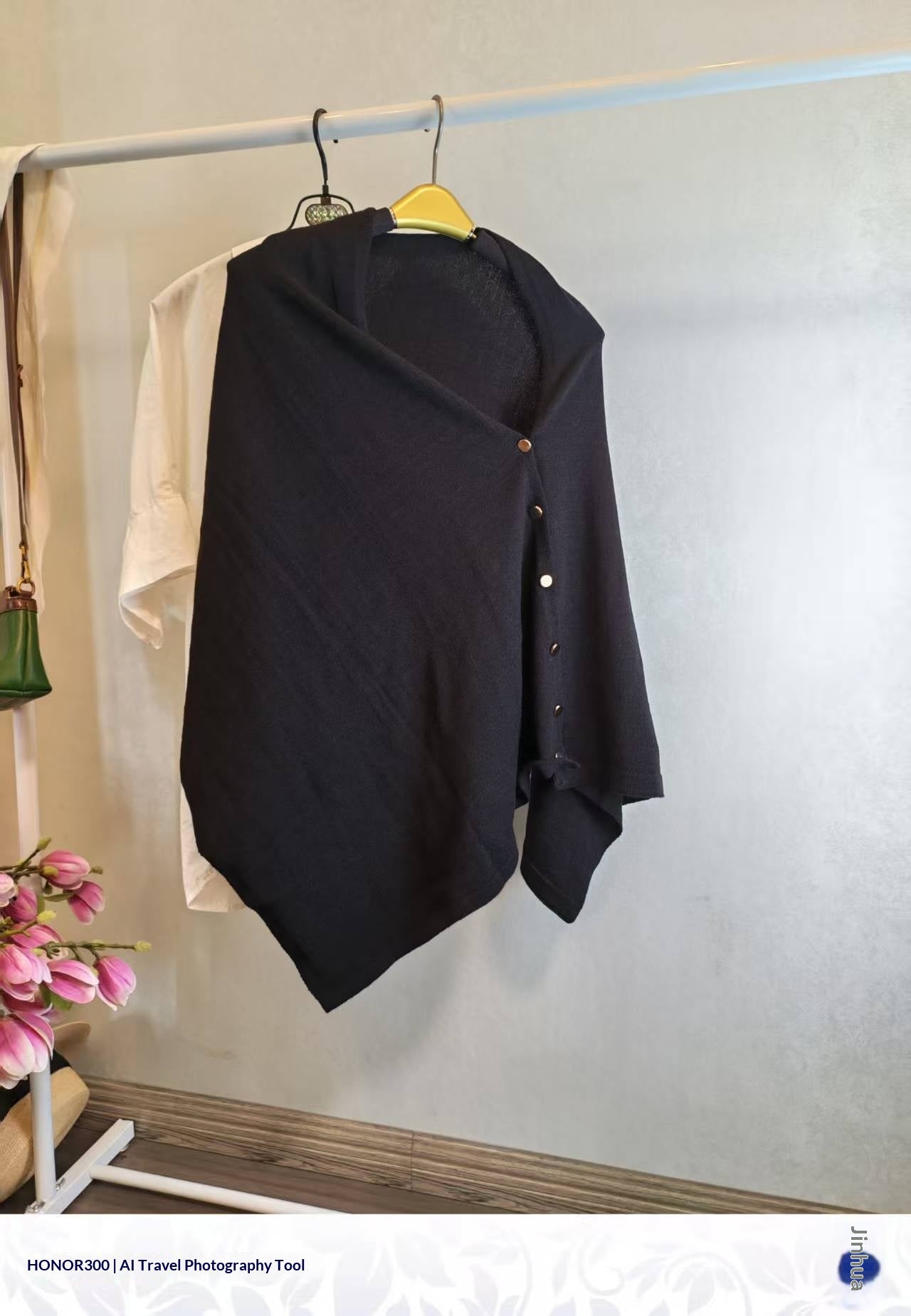 Black slouchy knit women's shawl with button detail, offering warm autumn style and sophisticated versatility.