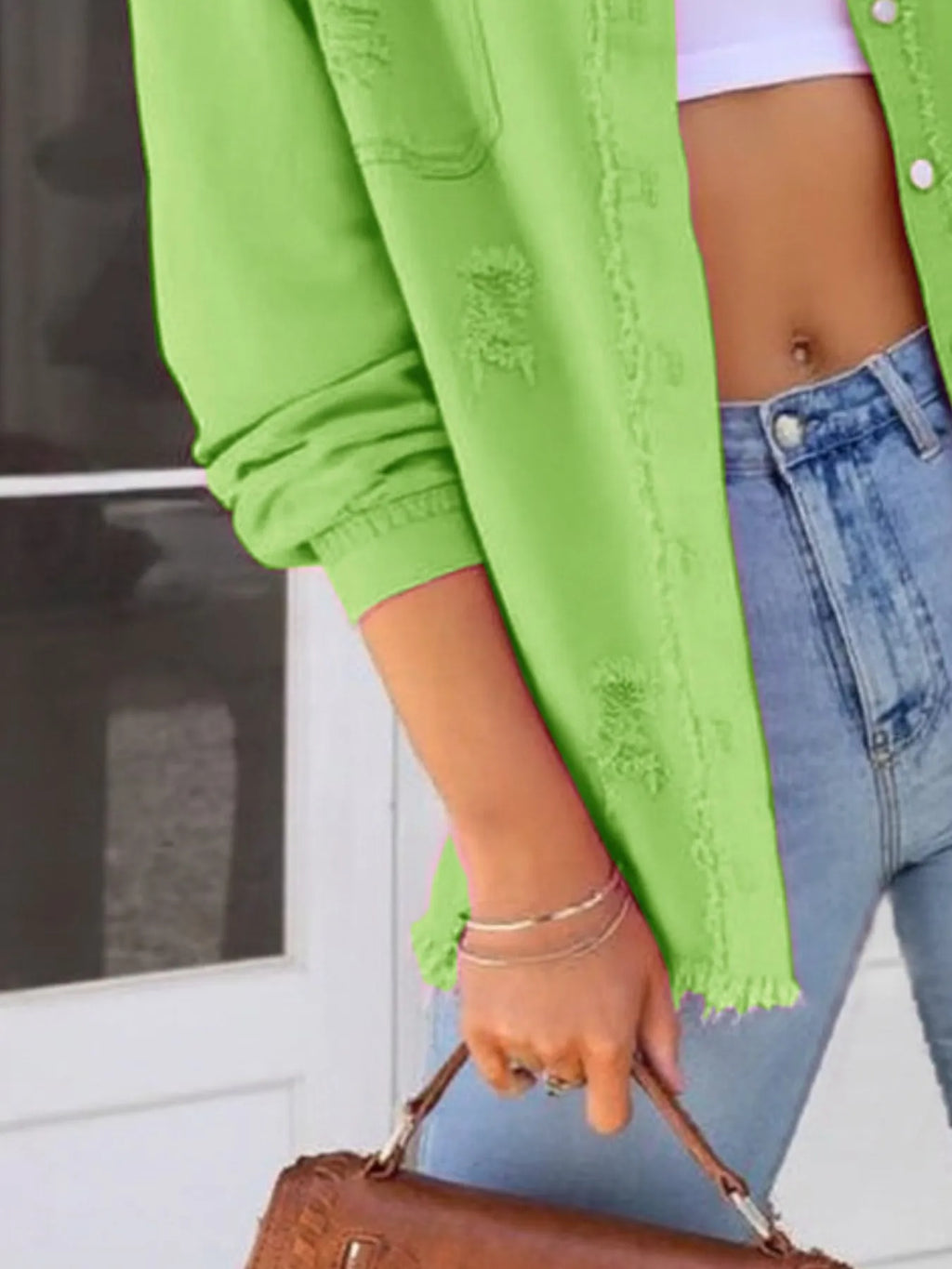 Distressed Denim Jacket with Frayed Edges.