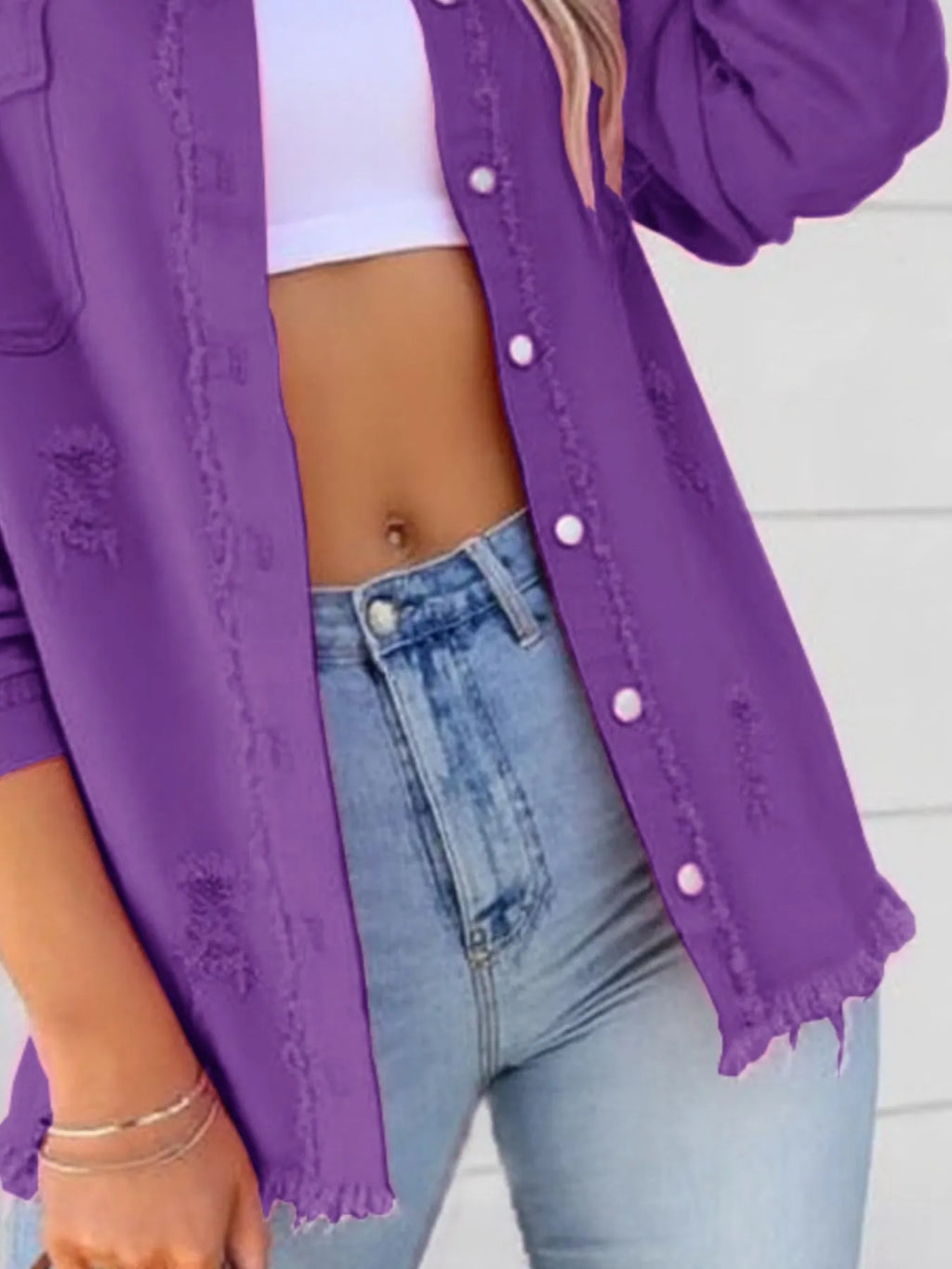 Distressed Denim Jacket with Frayed Edges.