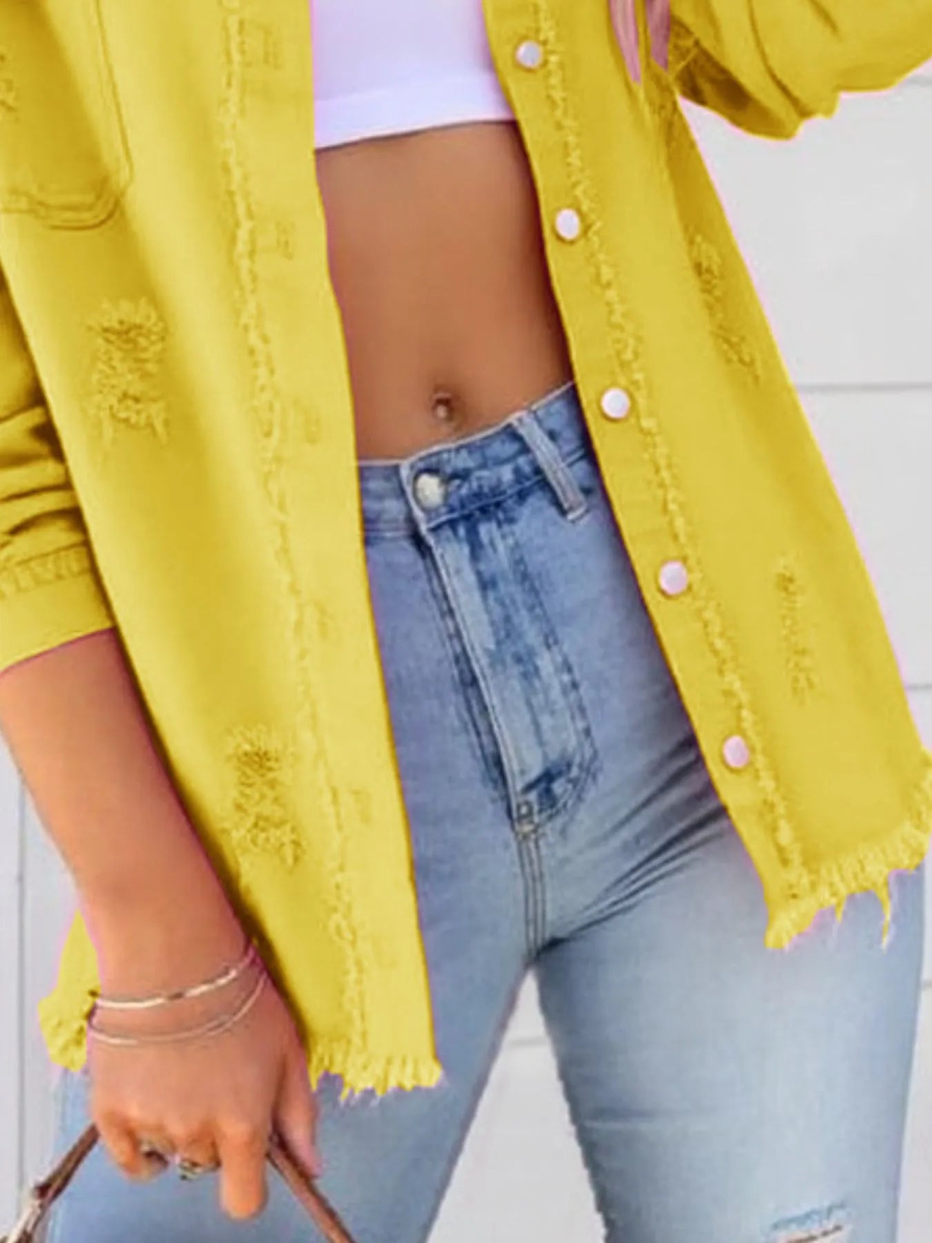 Distressed Denim Jacket with Frayed Edges.