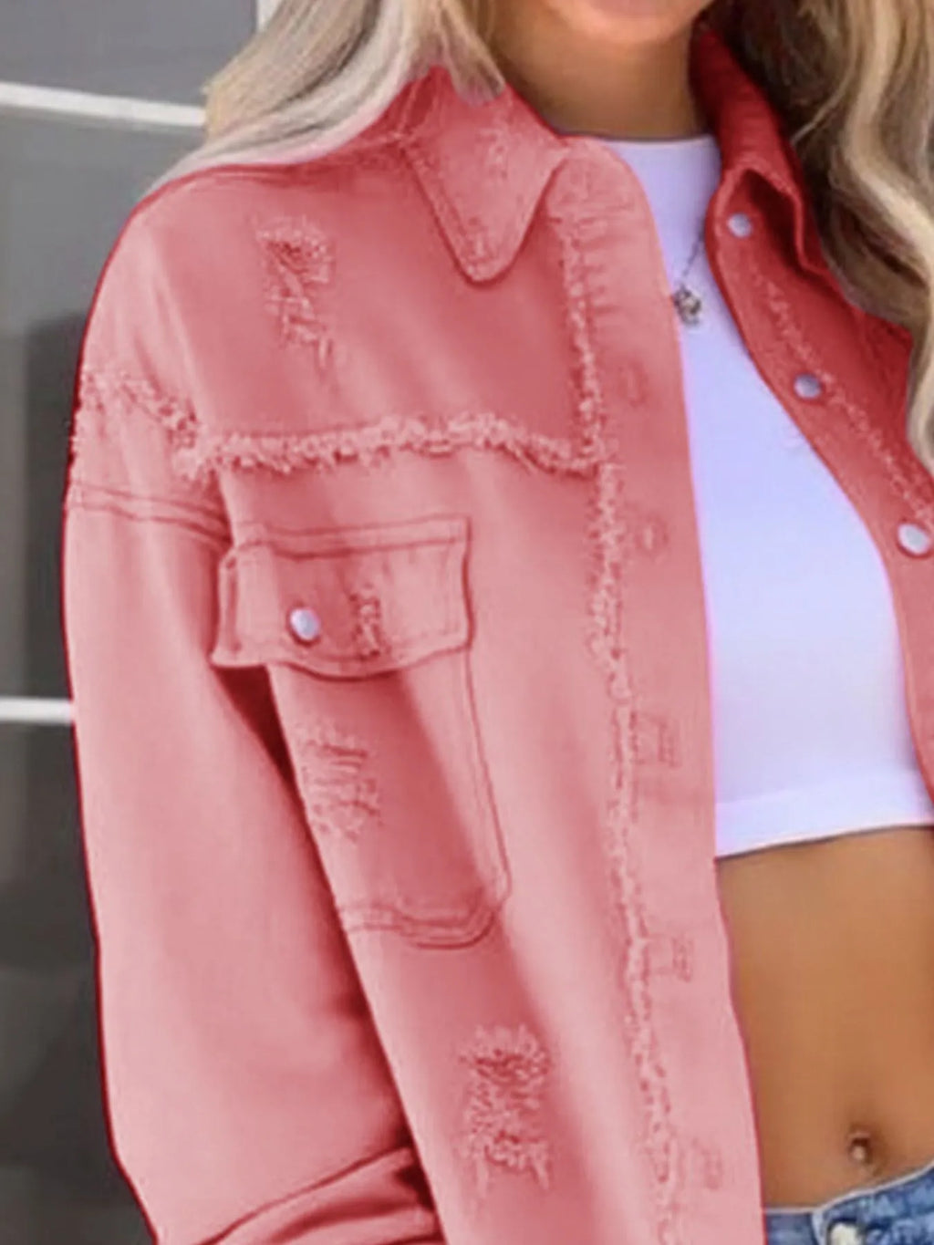 Distressed Denim Jacket with Frayed Edges.